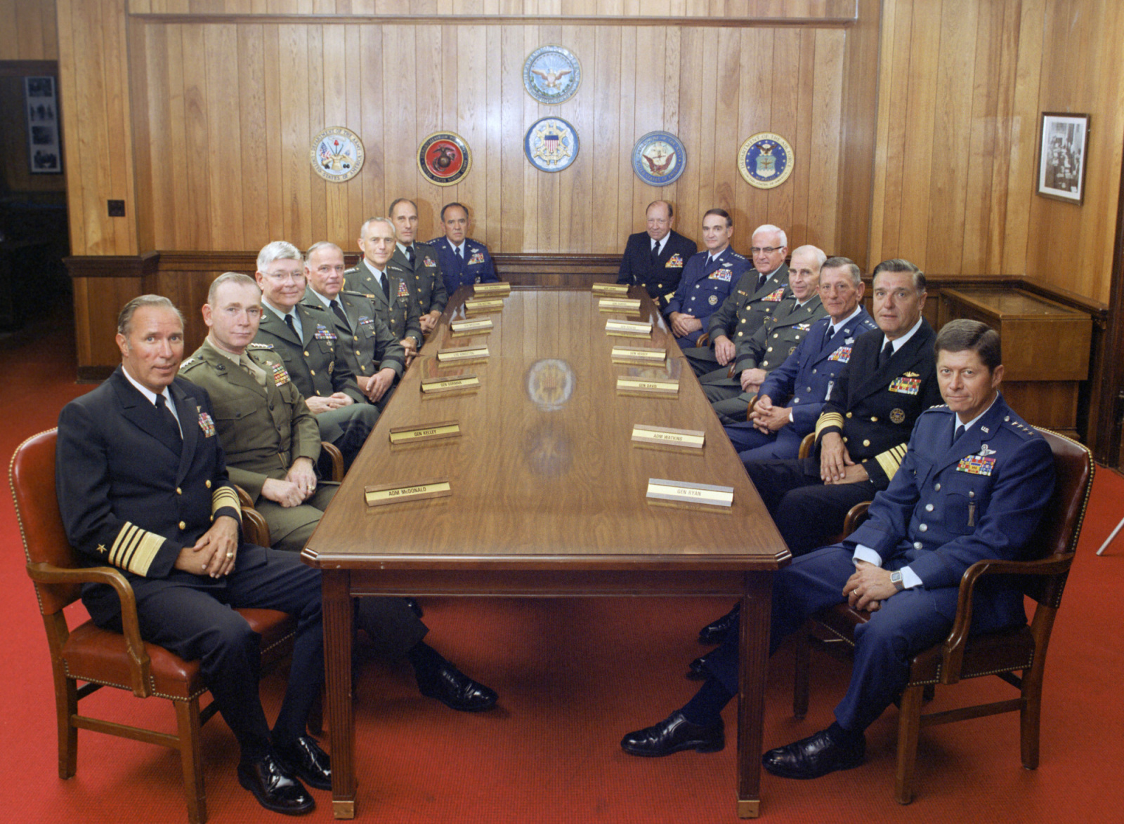 From Michael Moore's documentary, Where To Invade Next: This is a group photograph of the Joint Chiefs of Staff and several Commanders in Chiefs taken on July 1, 1983, in the Chairman of the Joint Chiefs of Staff dining room, located in the Pentagon. Shows (left to right): U.S. Navy Adm. Wesley L. McDonald, Commander in Chief, US Atlantic Command; U.S. Marine Corps Gen. Paul X. Kelley, Commandant of the Marine Corps; U.S. Army Gen. Paul F. Gorman, Commander in Chief, US Southern Command; U.S. Army Lt. Gen. Robert C. Kingston, Commander in Chief, US Central Command; U.S. Army Gen. John A. Wickham, Chief of Staff, US Army; U.S. Army Gen. Wallace H. Nutting, Commander in Chief, US Readiness Command; U.S. Air Force Gen. James V. Hartinger, Commander in Chief, Aerospace Defense Command; U.S. Navy Adm. William J. Crowe, Commander in Chief, US Pacific Command; U.S. Air Force Gen. Charles A. Gabriel, Chief of Staff, U.S. Air Force; U.S. Army Bernard W. Rogers, Commander in Chief, US European Command; U.S. Army Gen. John W. Vessey, Jr., Chairman of the Joint Chiefs of Staff; U.S. Air Force Gen. Bennie L. Davis, Commander in Chief, US Strategic Air Command; U.S. Navy Adm. James D. Watkins, Chief of Naval Operations; and U.S. Air Force Gen. Thomas M. Ryan, Commander in Chief, Military Airlift Command.  OSD Package No. A07D-00347 (DOD Photo by Robert D. Ward) (Released)